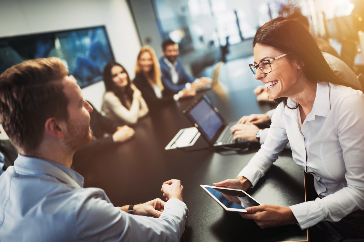 a smiling lady in a workplace.